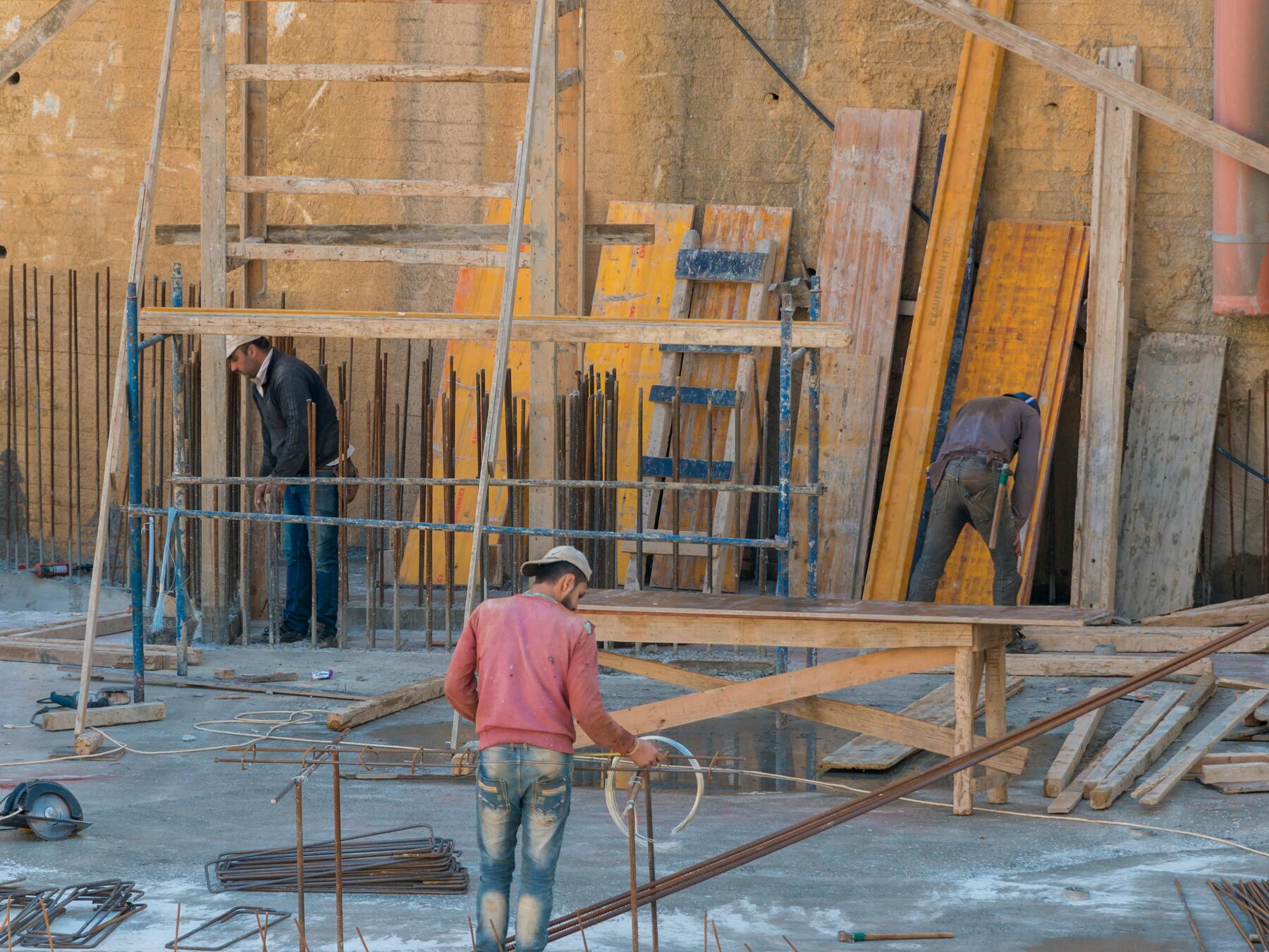 Crew setting rebar and formwork for a solid foundation